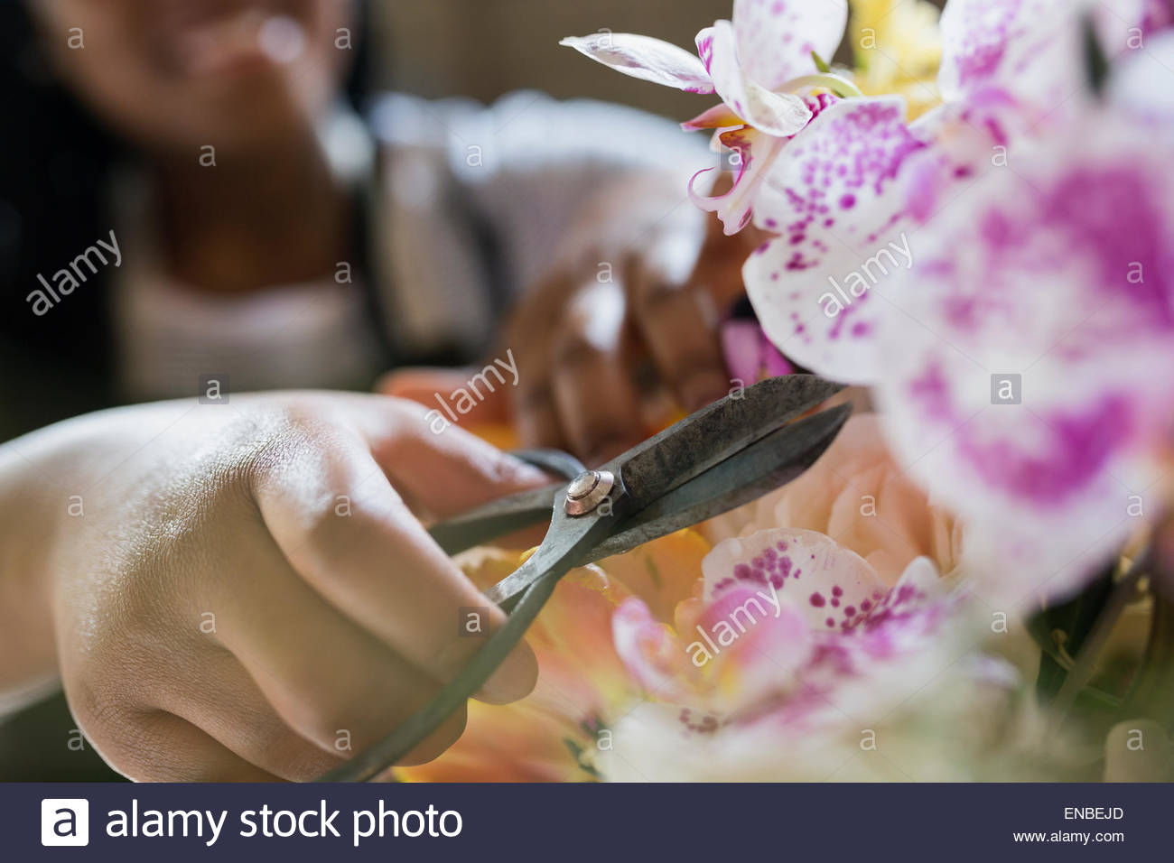 Close up florist with scissors arranging bouquet Stock Photo