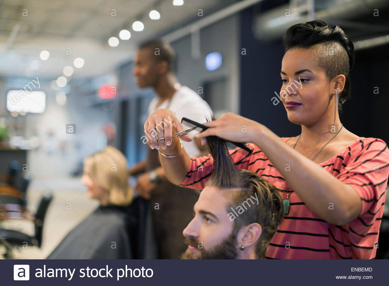 Female hairstylist cutting mans hair in hair salon Stock Photo Alamy