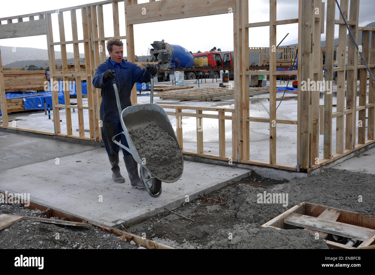 Builder pours concrete slab at a large building Stock Photo