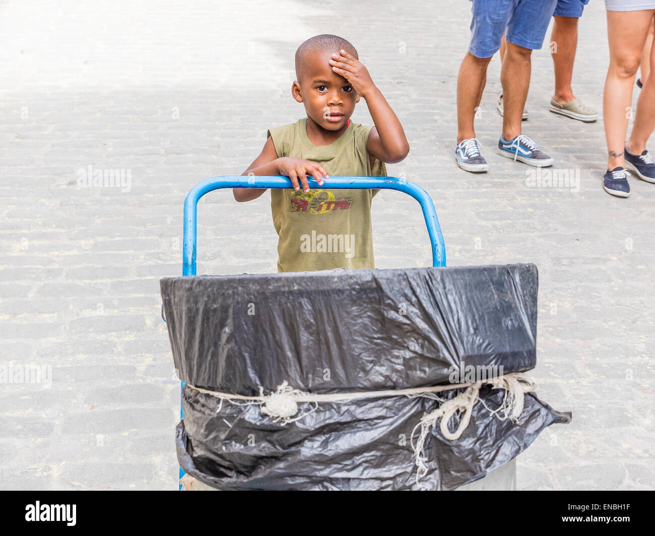 A young Cuban boy pushes a trash cart through the streets of Havana, Cuba Stock Photo Alamy