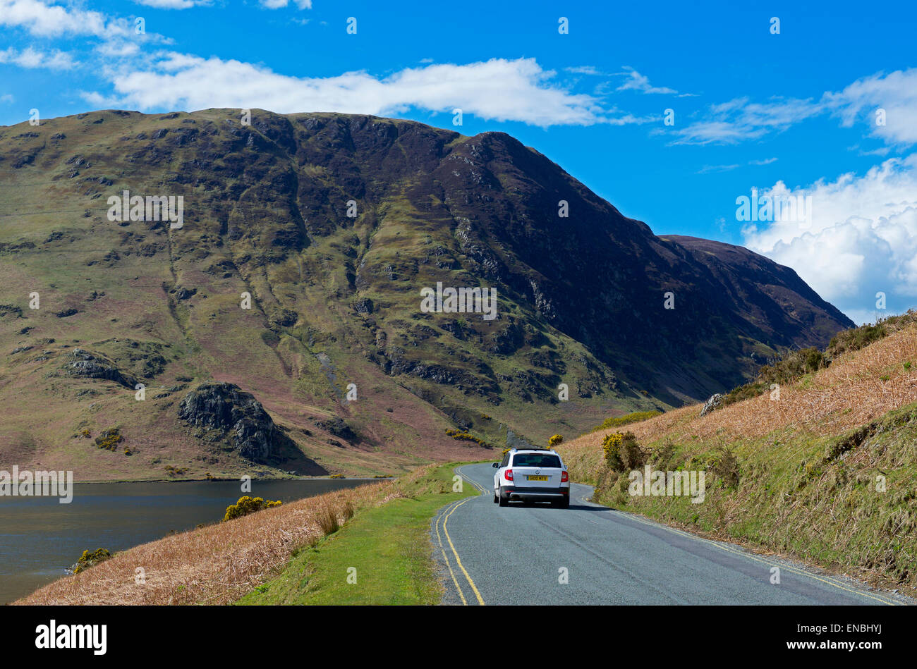Car on road by Crummockwater (B5289), Lake District National Park, Cumbria, England UK Stock