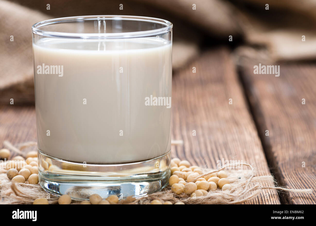 Glass with Soy Milk and Seeds on wooden background Stock Photo