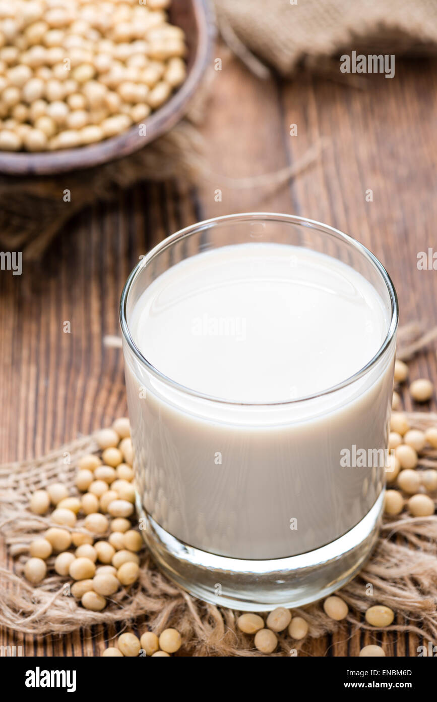 Soy Milk with some Seeds (close-up shot) on wooden background Stock Photo