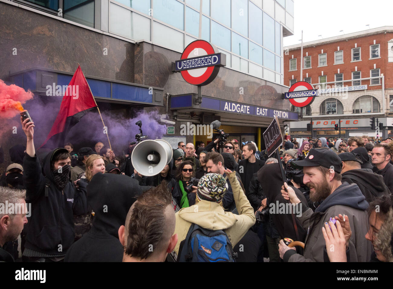 London, 1st May 2015 Anti-capitalist protesters set off flares before they march through central London from Aldgate East tube station to Frith Street in Soho as part of a May day anti-gentrification protest. Credit:  Patricia Phillips/Alamy Live News Stock Photo