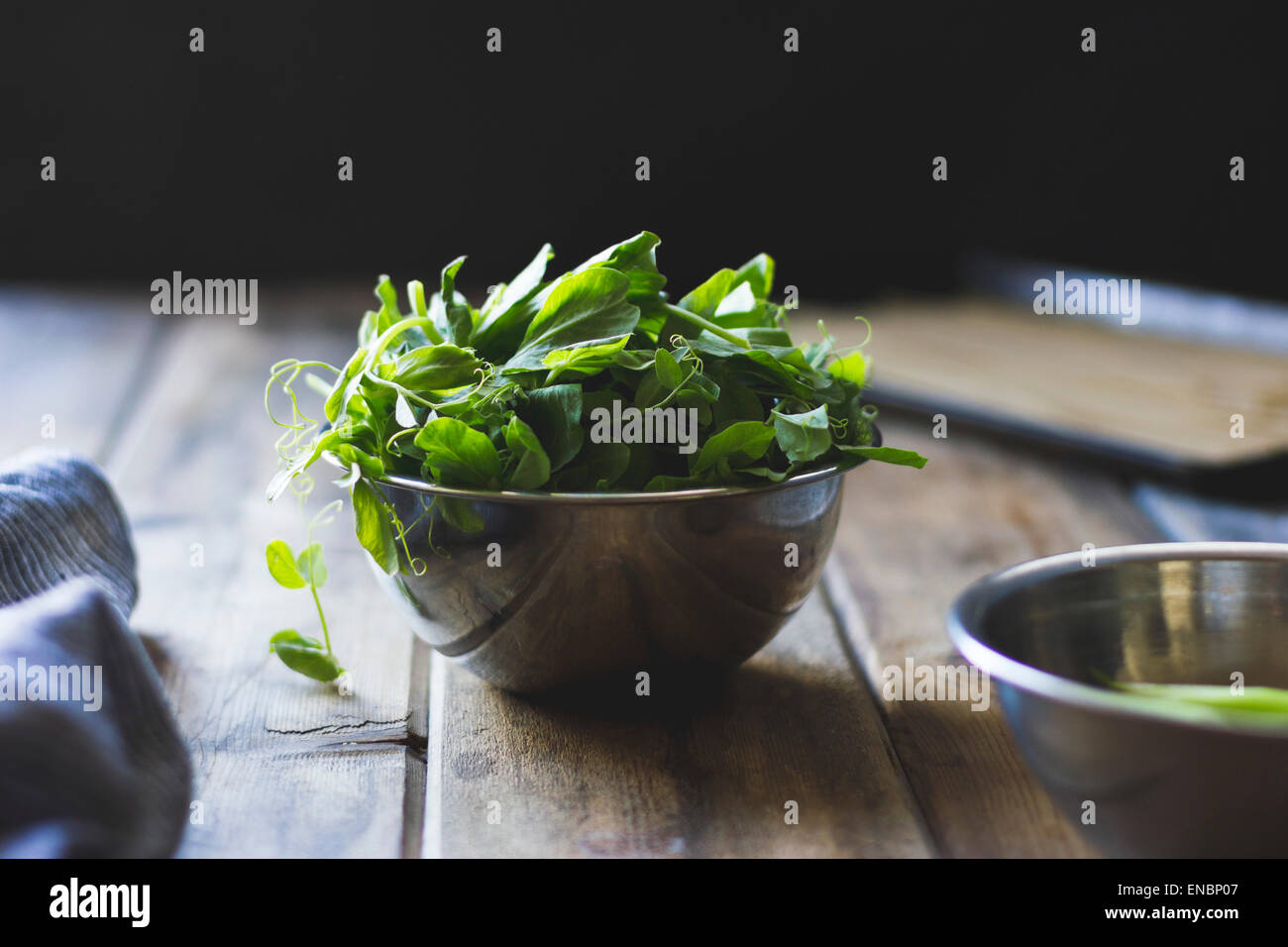 Pea shoots in a metallic bowl Stock Photo