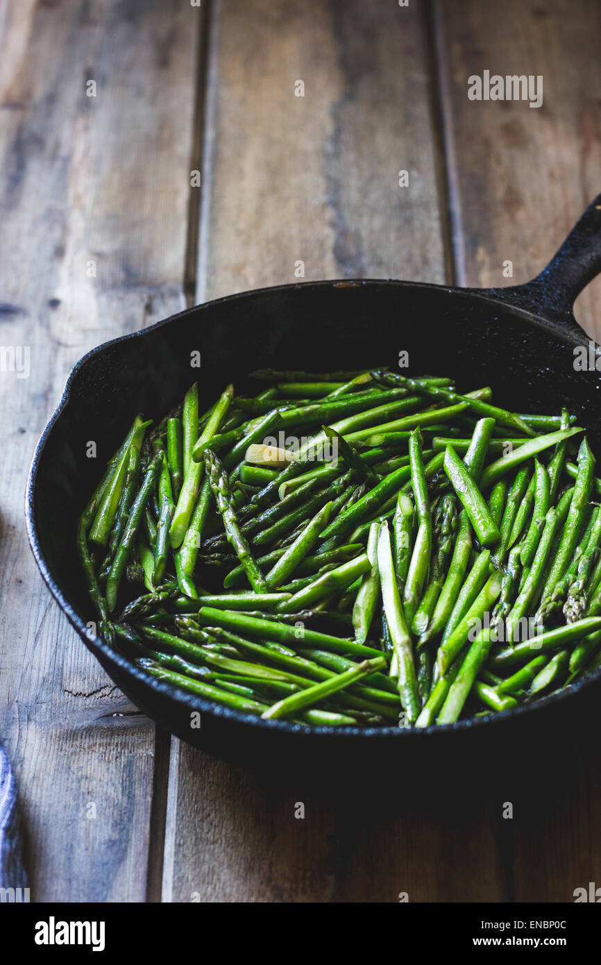 Asparagus spears in a frying pan Stock Photo
