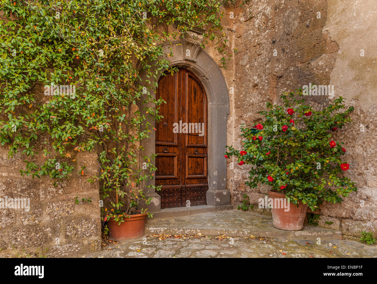 Wooden door entrance to rustic dwelling in Civita di Bagnoregio, Italy Stock Photo