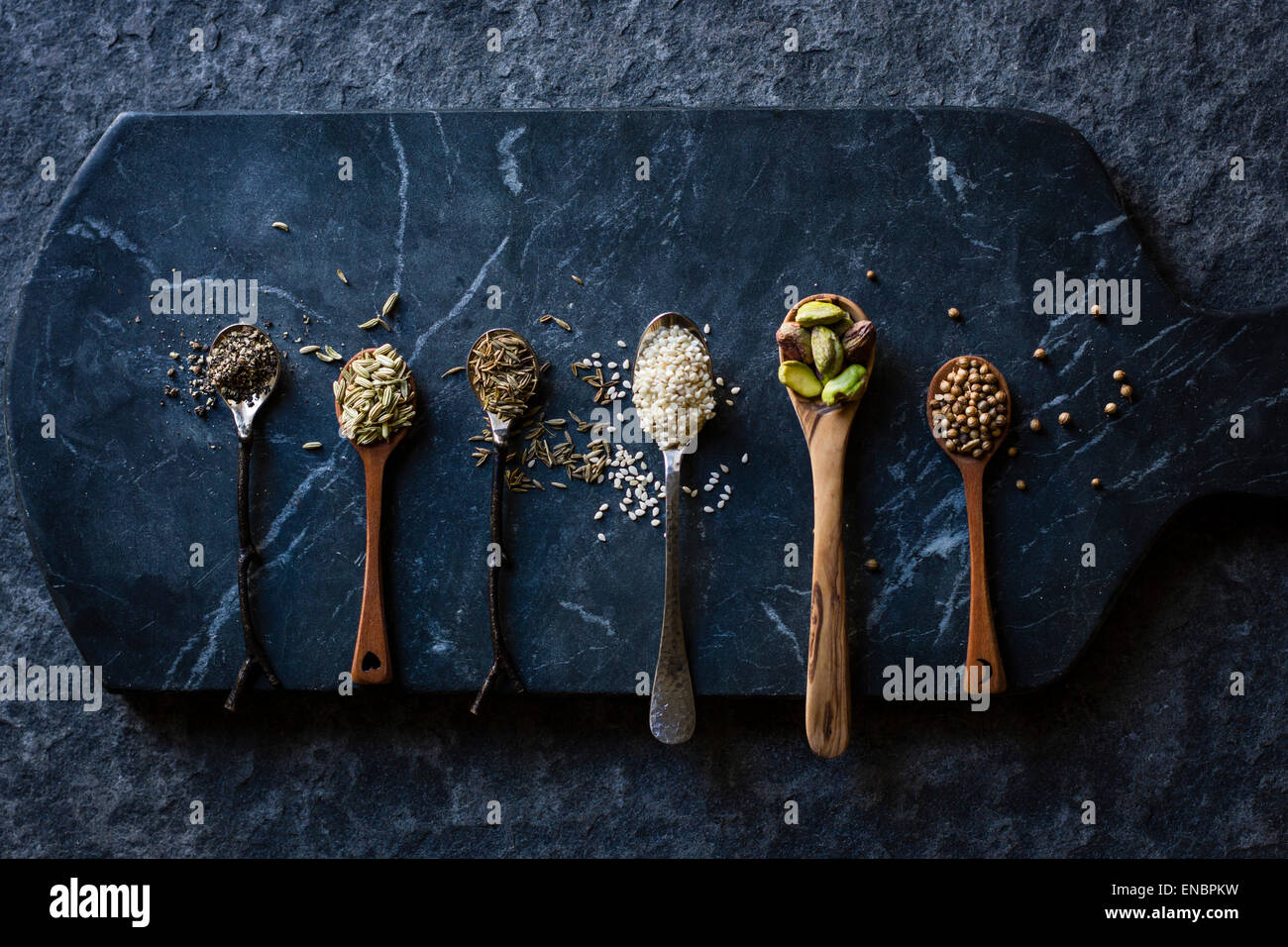Grains, seeds and nuts on spoons Stock Photo