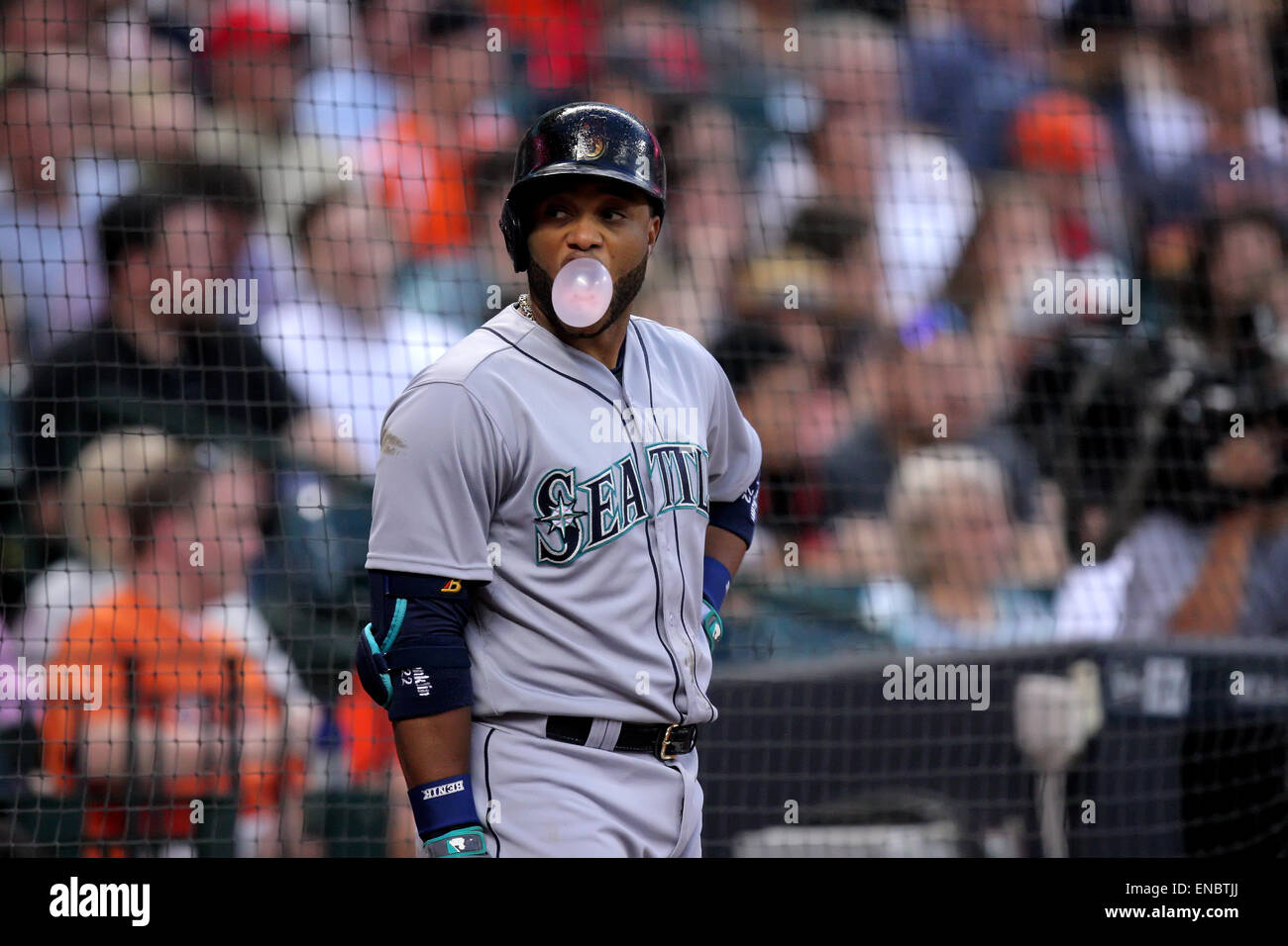 Seattle Mariners' Robinson Cano blows a bubble with his gum as he rounds  the bases after hitting a solo home run during the first inning of a  baseball game against the Cleveland