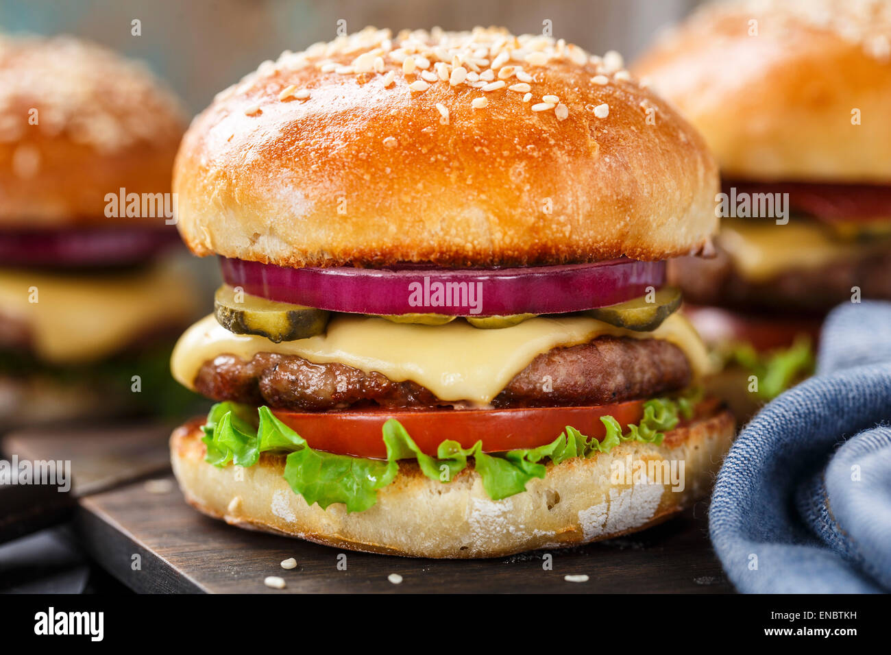 Delicious burger with beef, bacon, cheese and vegetables Stock Photo