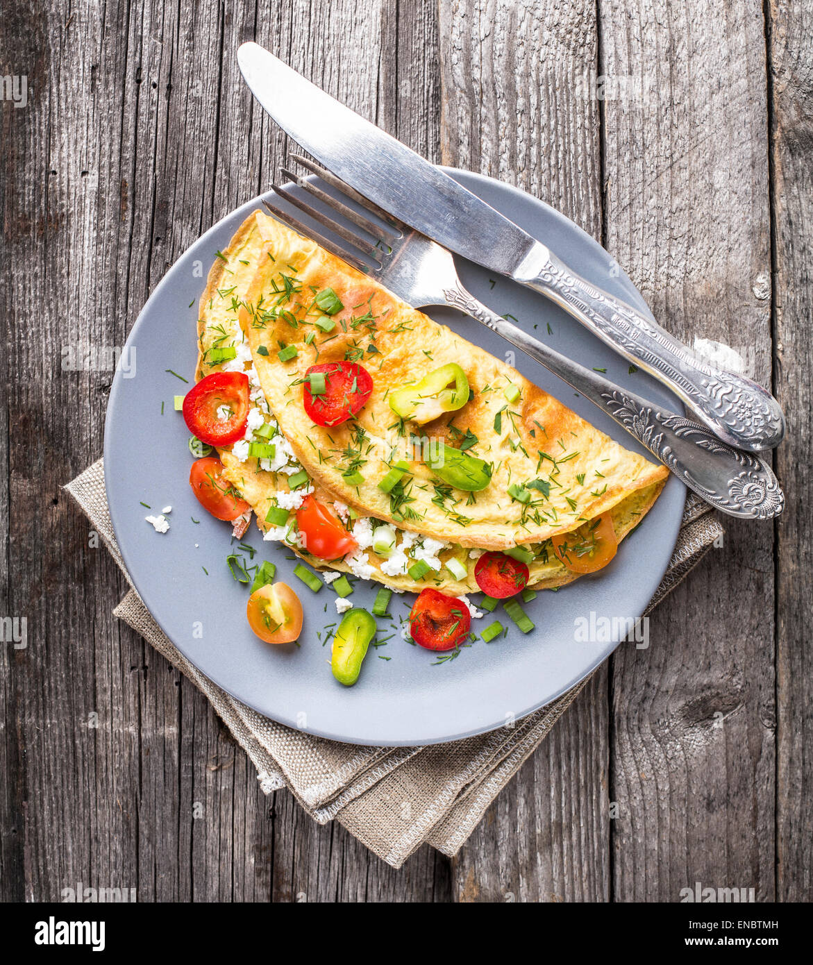 Omelette with vegetables and herbs on a plate Stock Photo