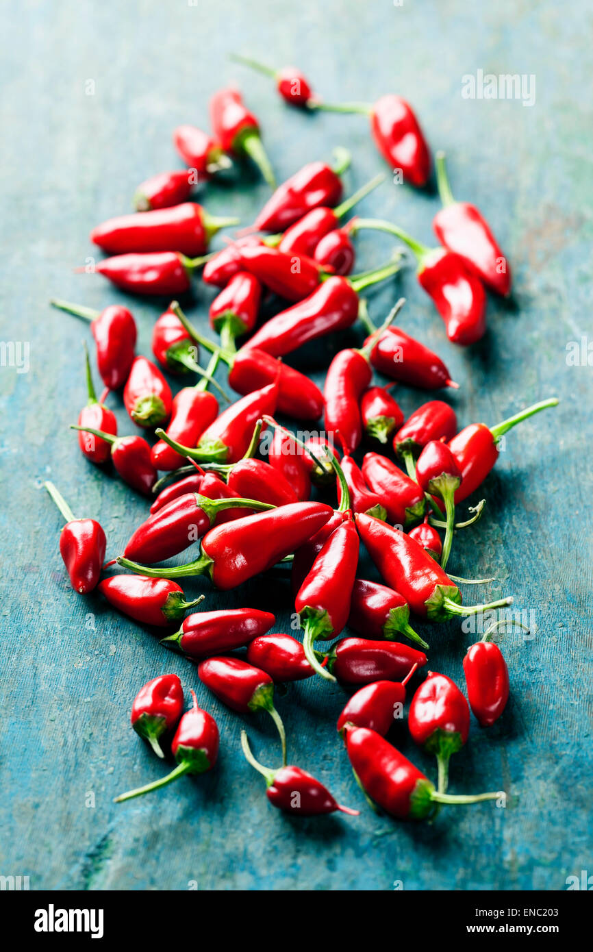 Red Hot Chili Peppers over wooden background Stock Photo - Alamy