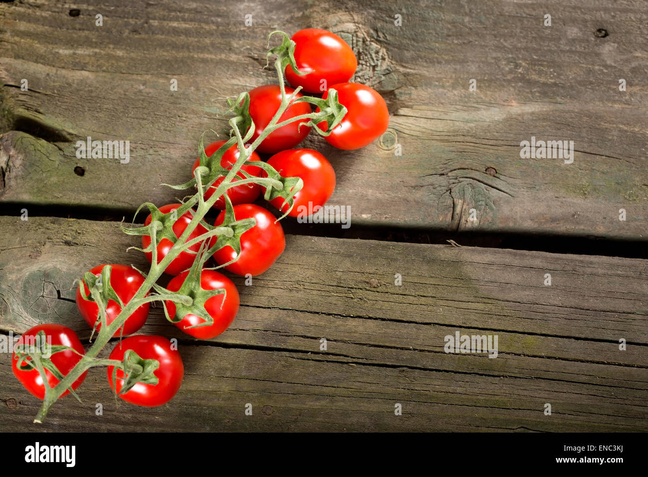 Some cherry tomatoes on a wooden surface with copy space Stock Photo