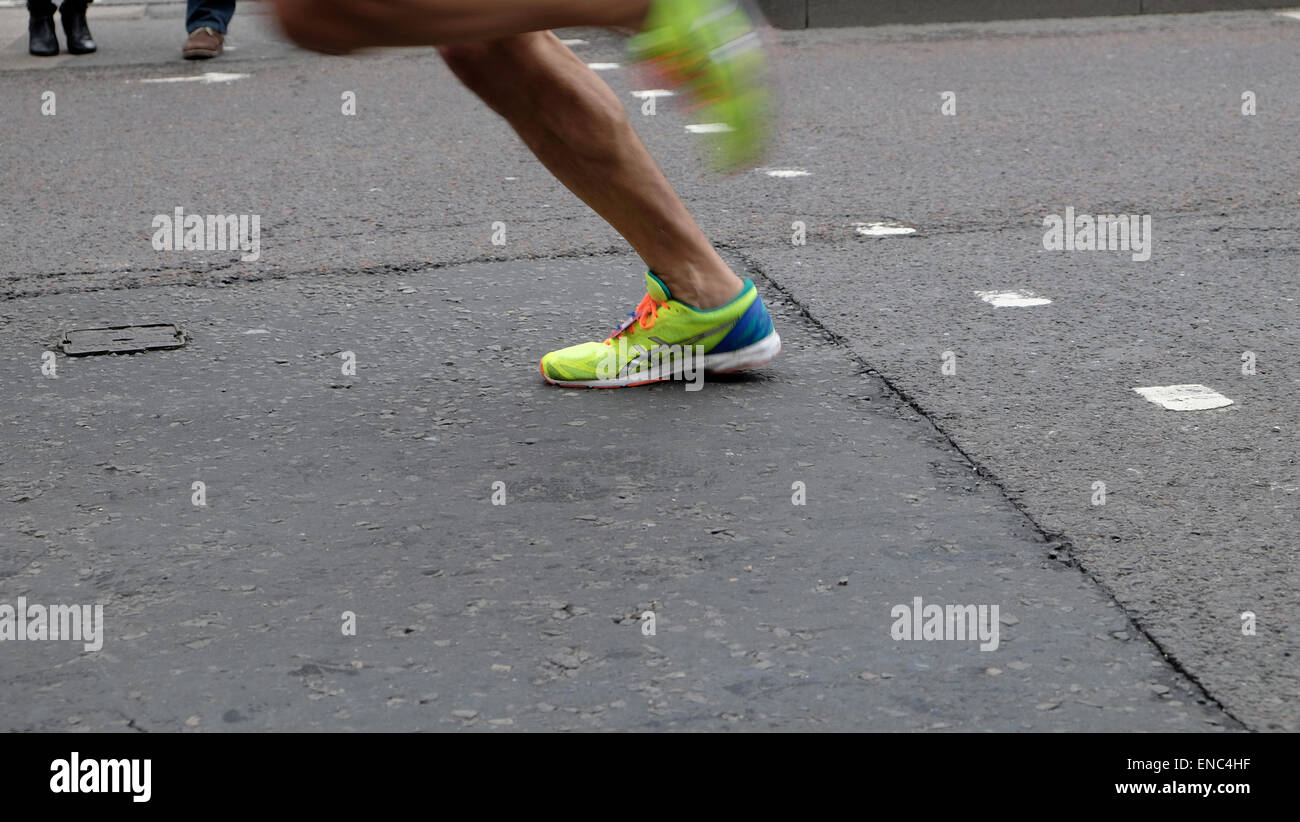 Detail of legs and shoes of a 2015 London Marathon runner running along