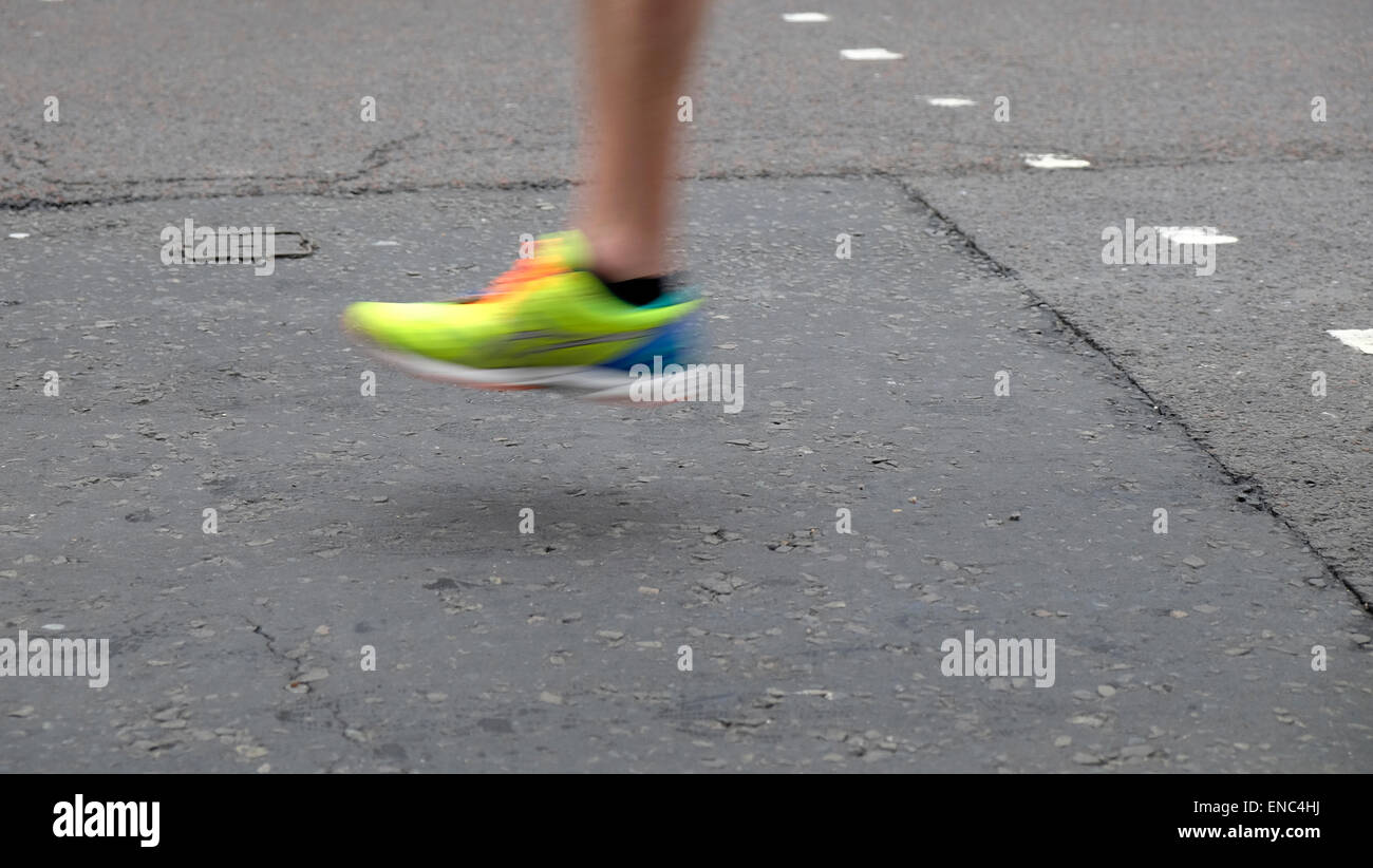 Detail of leg and shoe of 2015 London Marathon competitor running along
