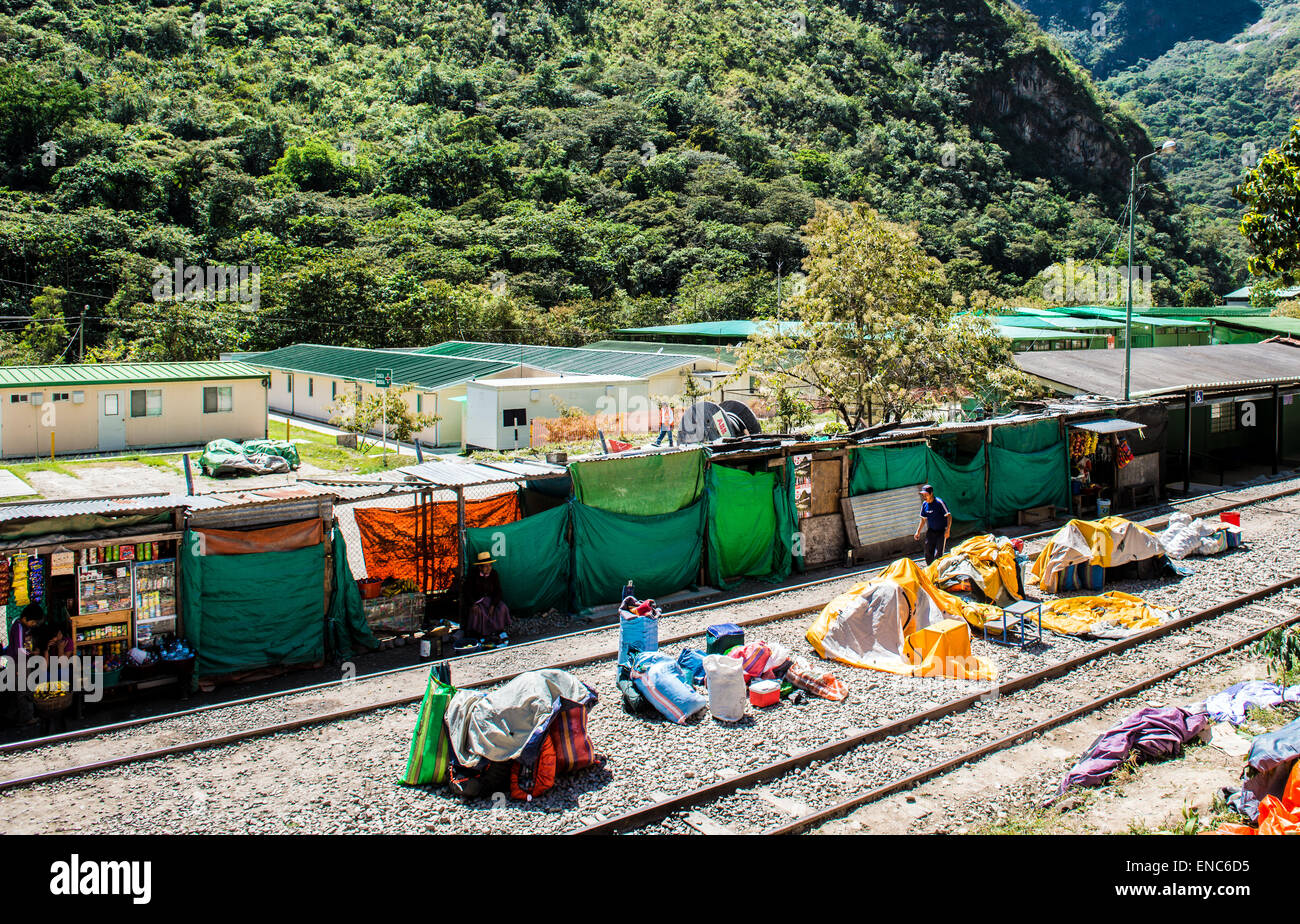 Porters setting out their tents and cooking equipment  at the end of the Salkantay trek in the Hidroelectrica railway station Stock Photo