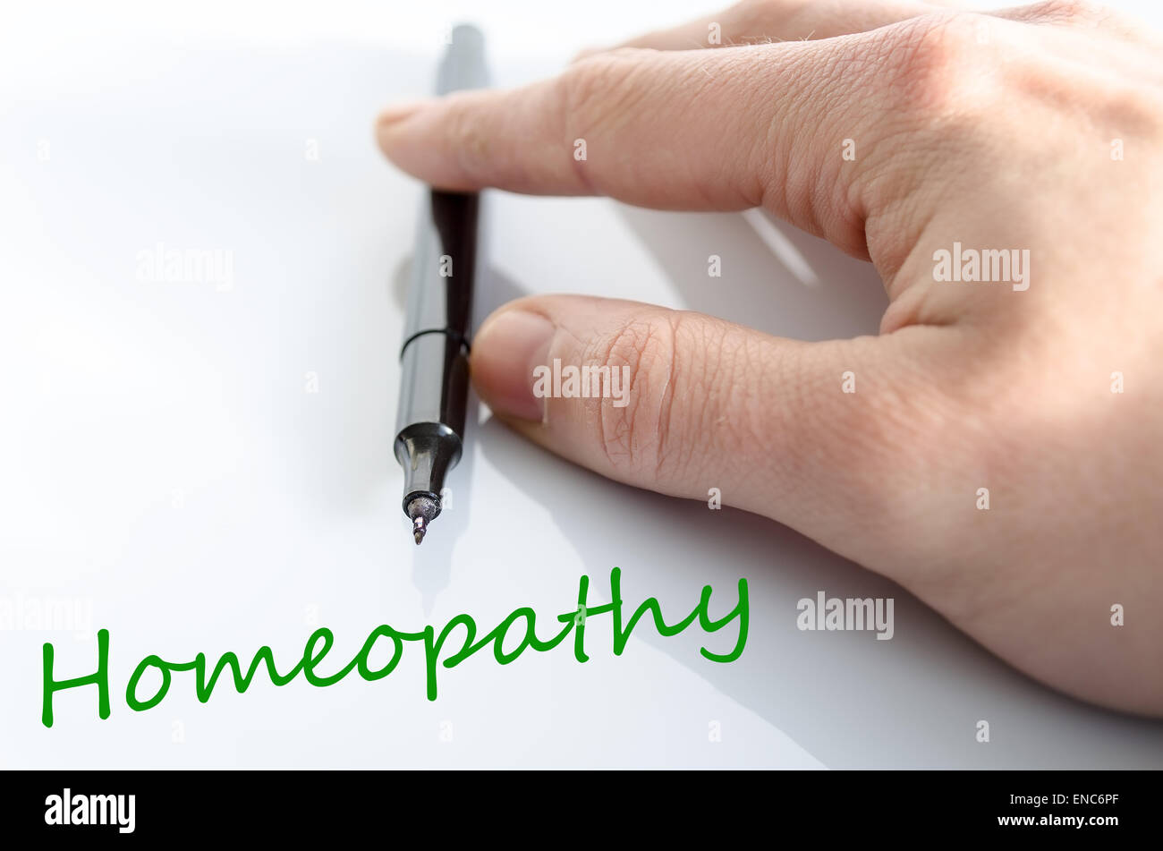 Pen in the hand isolated over white background homeopathy concept Stock Photo
