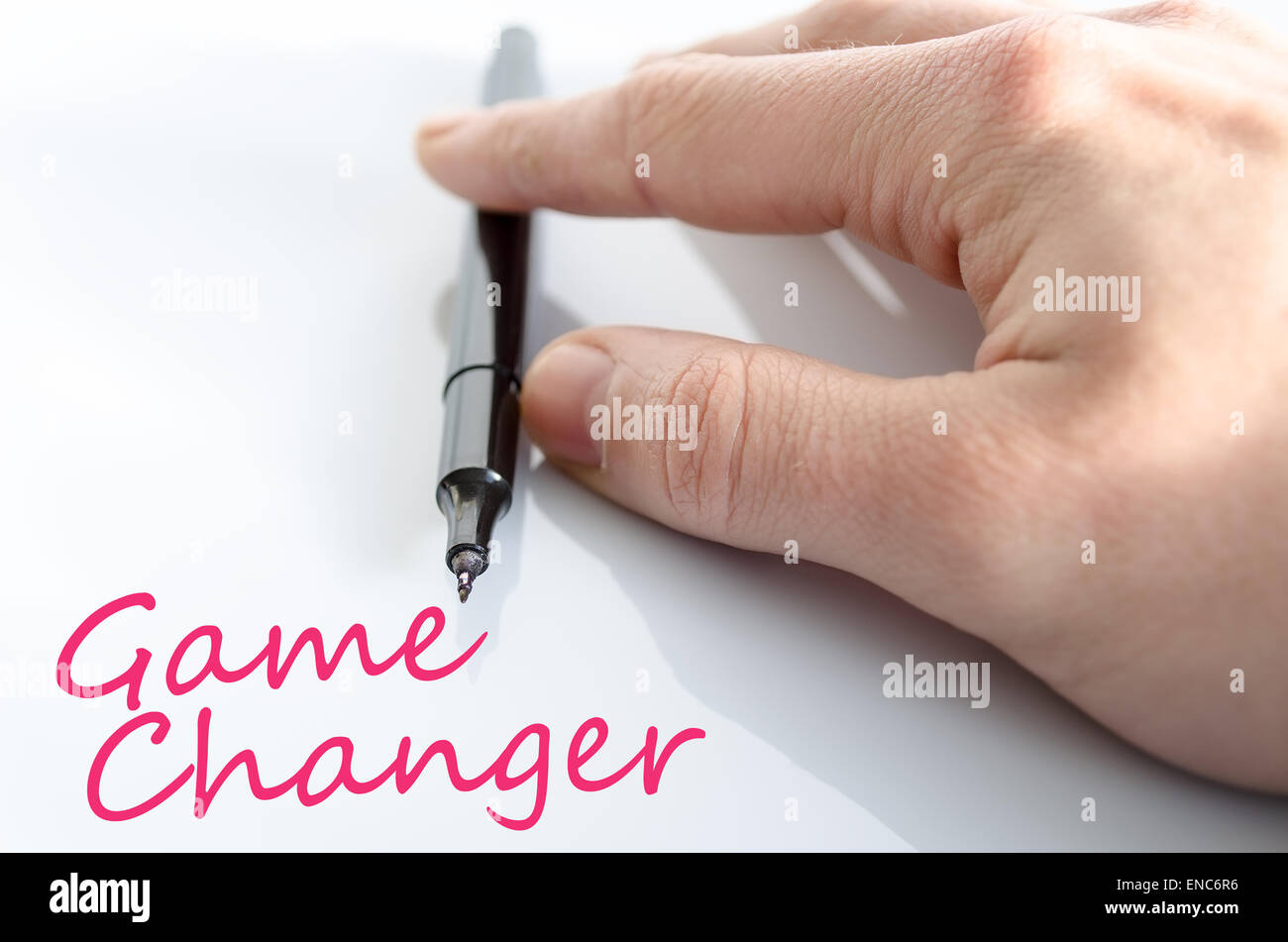 Pen in the hand isolated over white background game changer concept Stock Photo