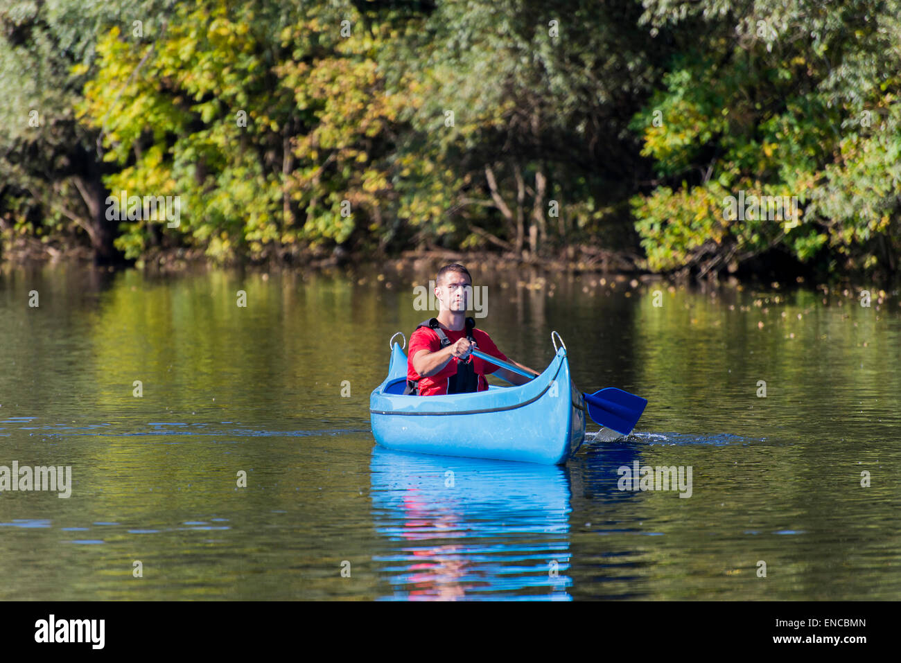 Young man in canoe Stock Photo