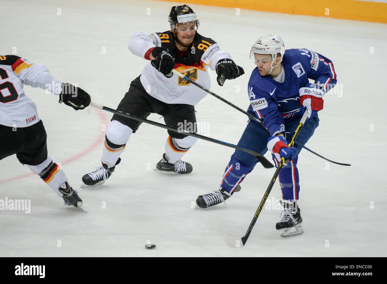 Prague, Czech Republic. 02nd May, 2015. Germany's Moritz Mueller (C) and France's Stephane Da Costa vie for the puck during the Ice Hockey World Championship match between France and Germany in the O2 Arena in Prague, Czech Republic, 02 May 2015. Photo: ARMIN WEIGEL/dpa/Alamy Live News Stock Photo