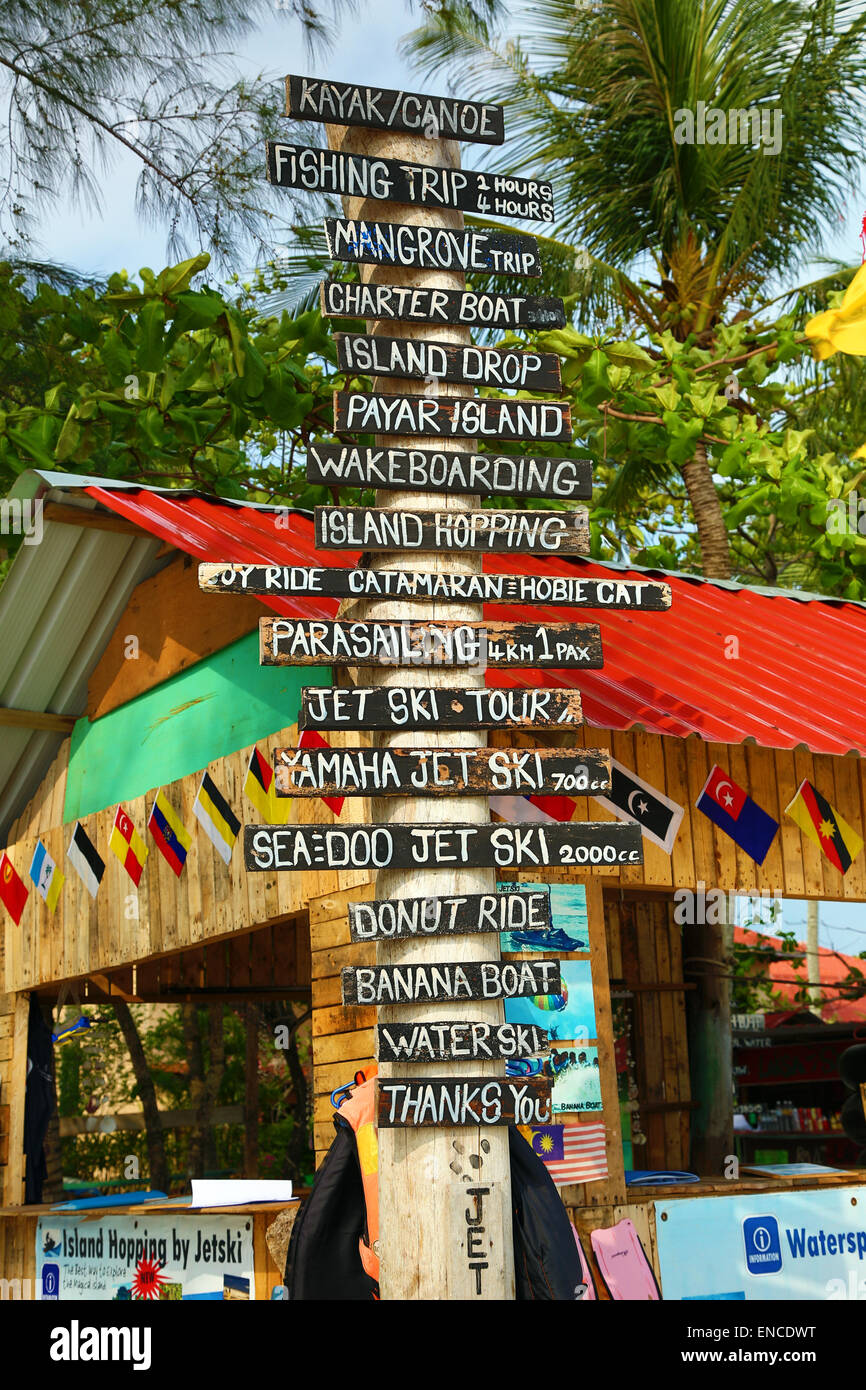 Tourist activities signs and hut on the beach in Pantai Cenang, Langkawi, Malaysia Stock Photo