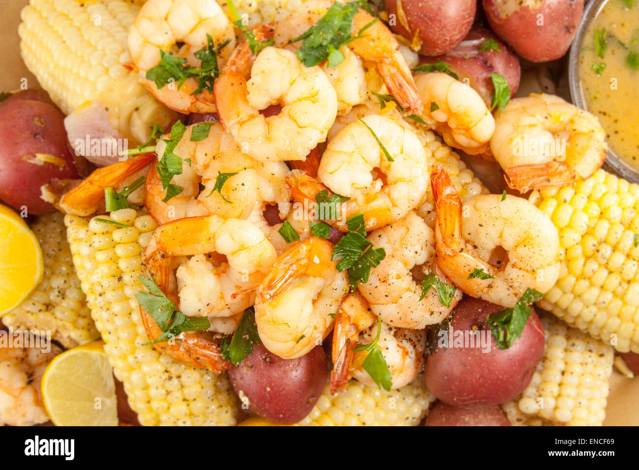 shrimp boil with corn, red potatoes and lemon Stock Photo