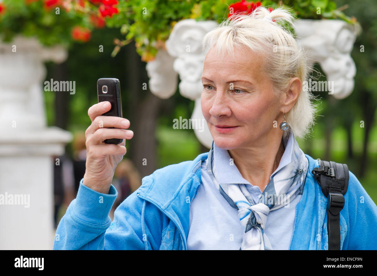a middle-aged woman photographed in a park on the phone Stock Photo - Alamy