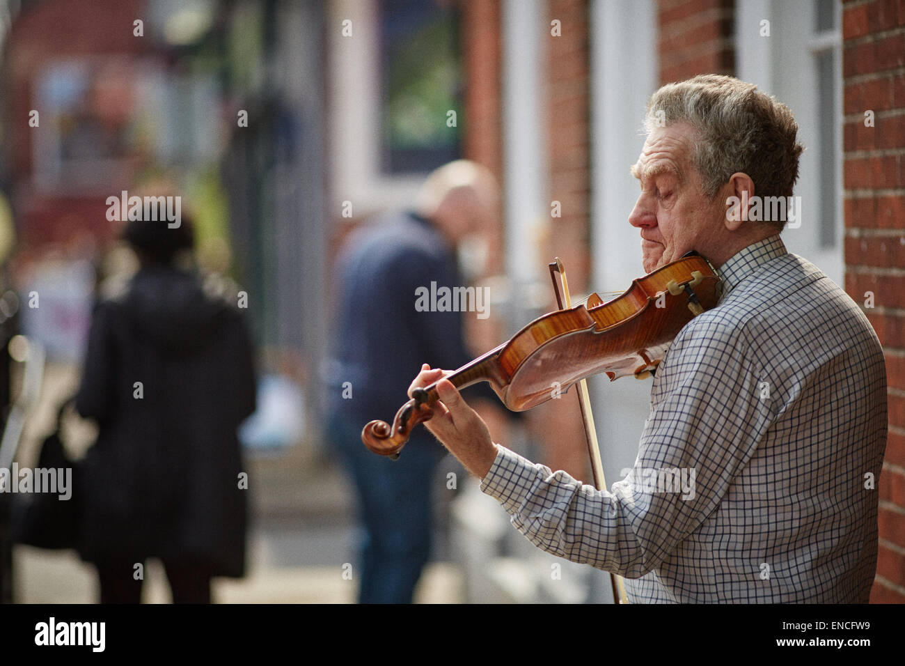 Violin playing street busker in Didsbury South manchester village Stock Photo