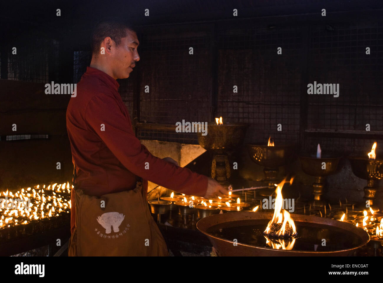monk lighting the candle Stock Photo Alamy