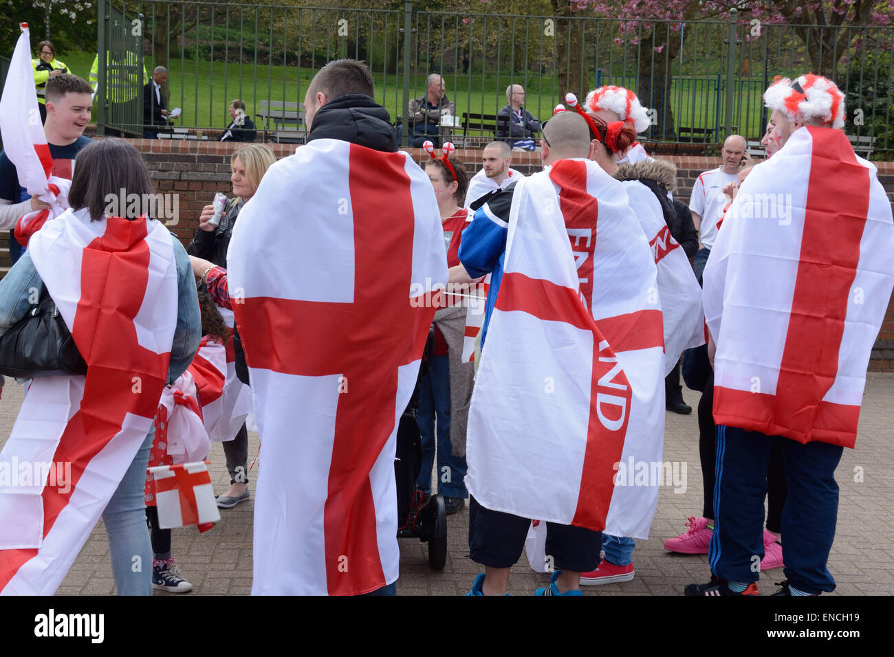 St. day parade. Marchers massing, wrapped in flags of St