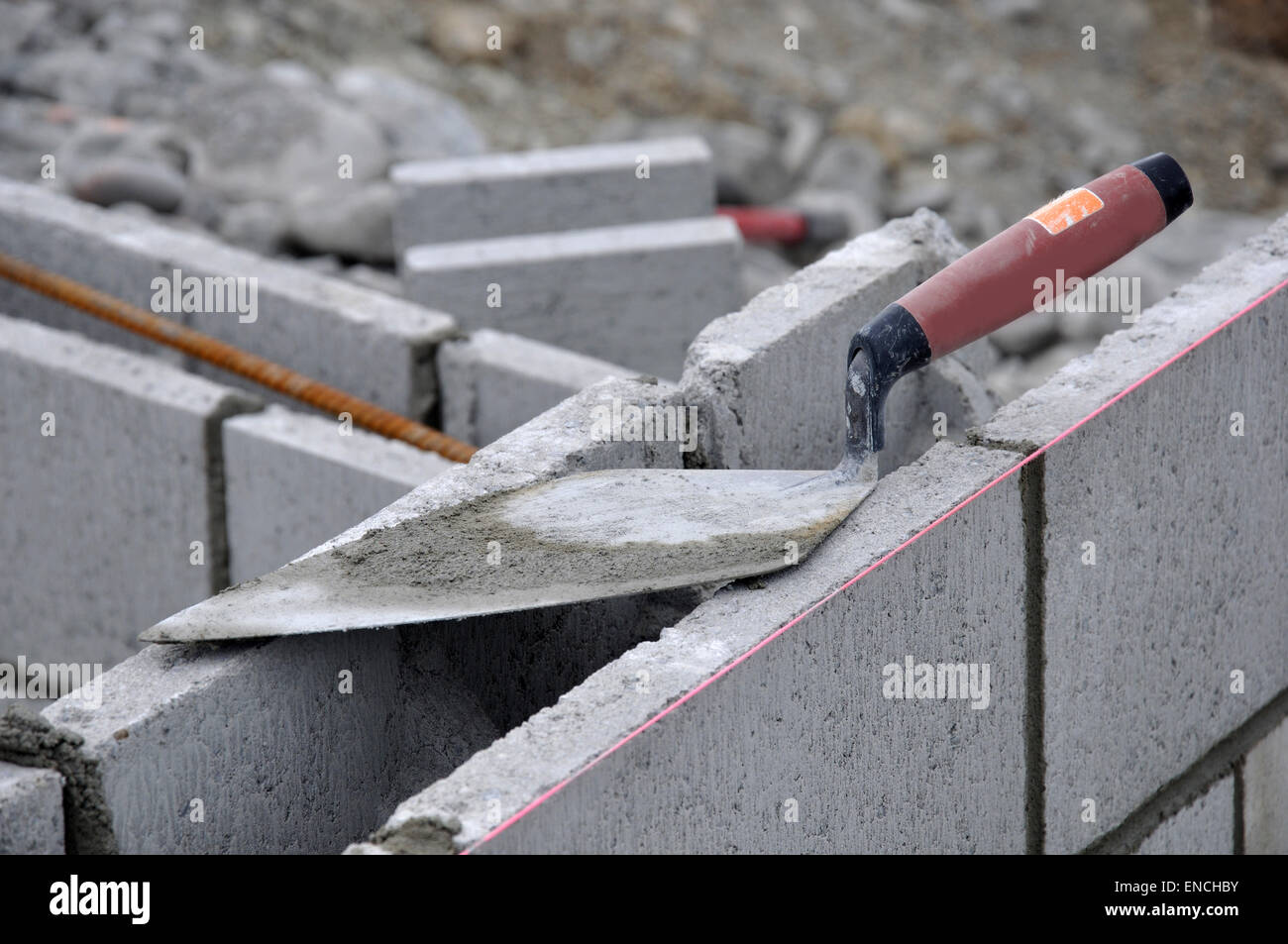 Building tools left on concrete block wall Stock Photo