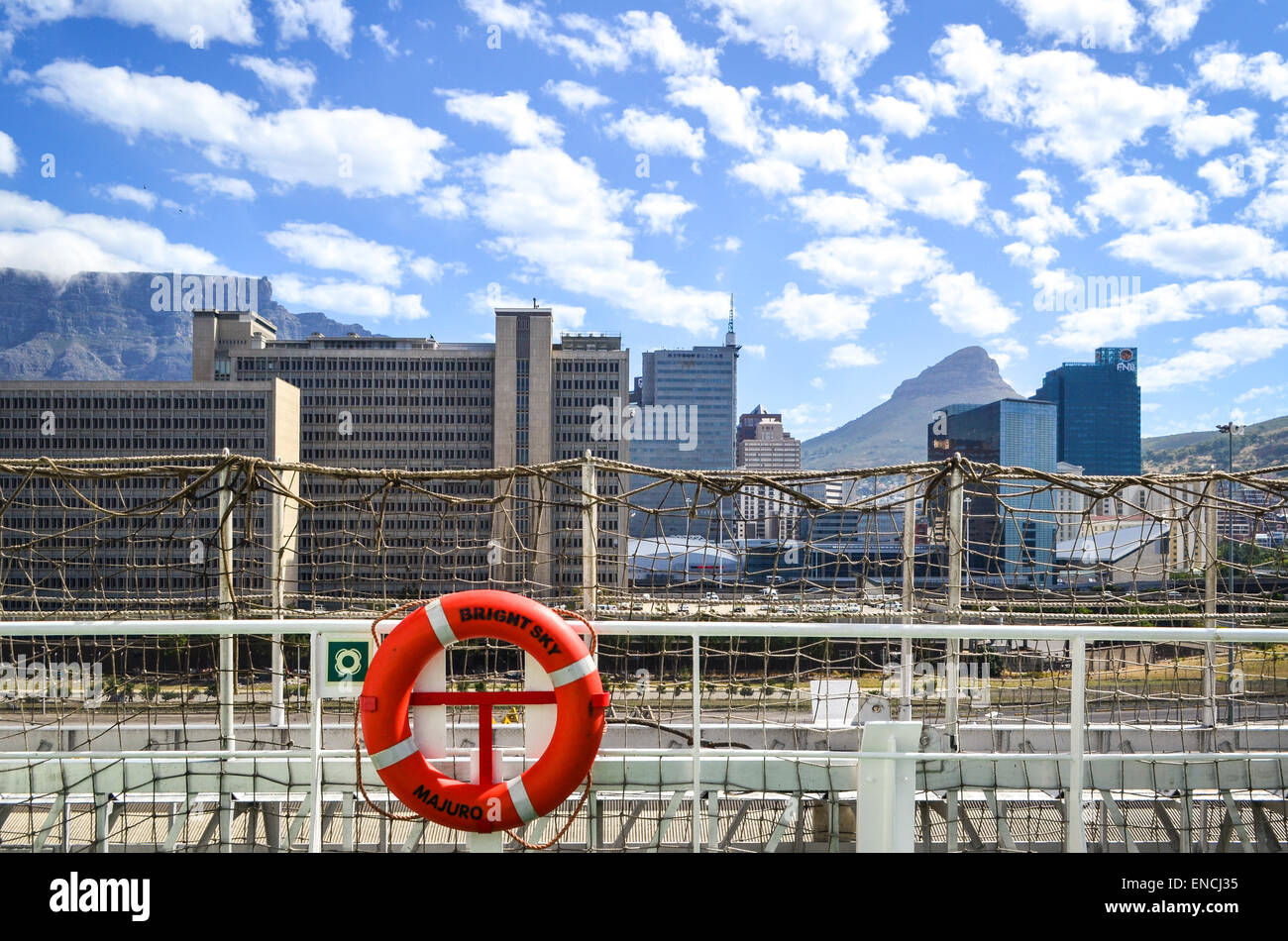 'bright sky' lifebuoy in the port of Cape Town, South Africa, in front of Cape Town CBD, Civic centre, and Table mountain Stock Photo