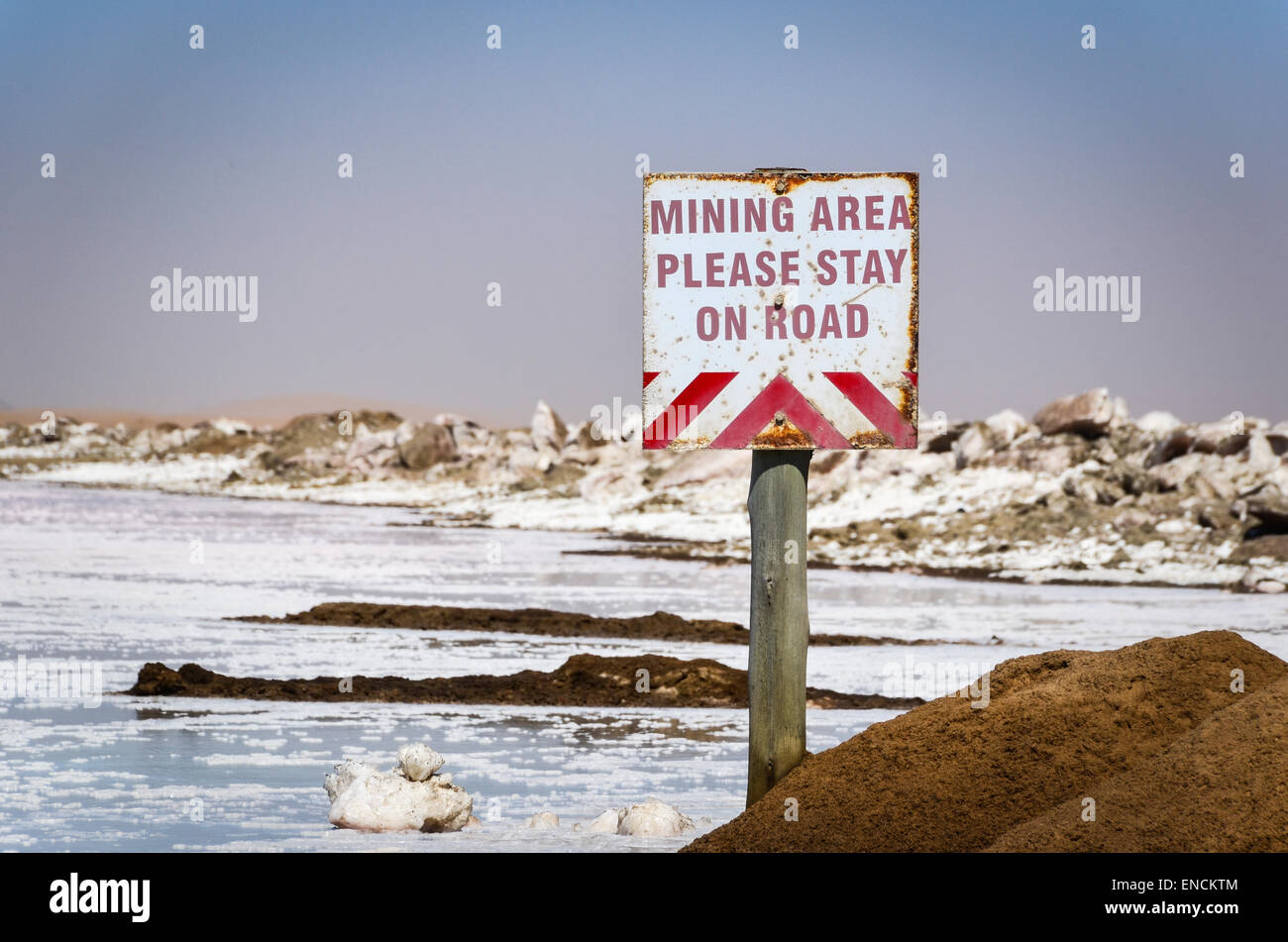 Salt works in Walvis Bay, Namibia, salt crystals, and sign reading 'Mining area, please stay on road' Stock Photo