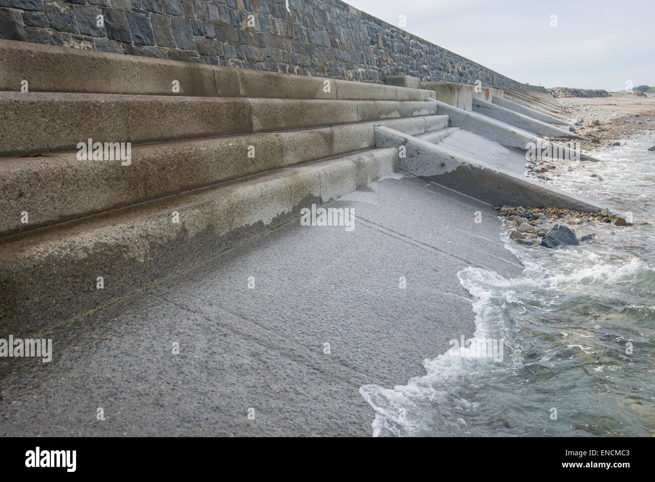 Concrete & granite sea wall on the west coast of Guernsey, Channel Islands. Stock Photo