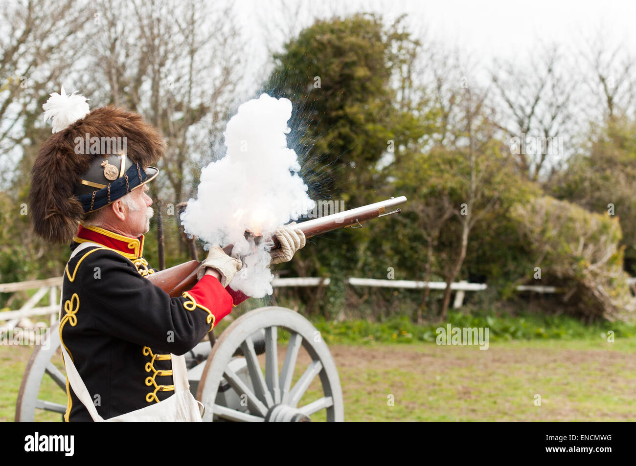 An historic musket  is fired by a Militia skirmisher during a rehearsal for a  re-enactment of Warterloo. Stock Photo