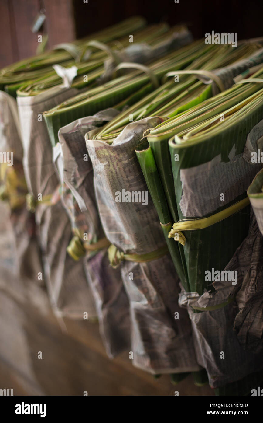 Folded banana leaves wrapped in newspaper & tied, Chinatown, Bangkok, Thailand. Stock Photo