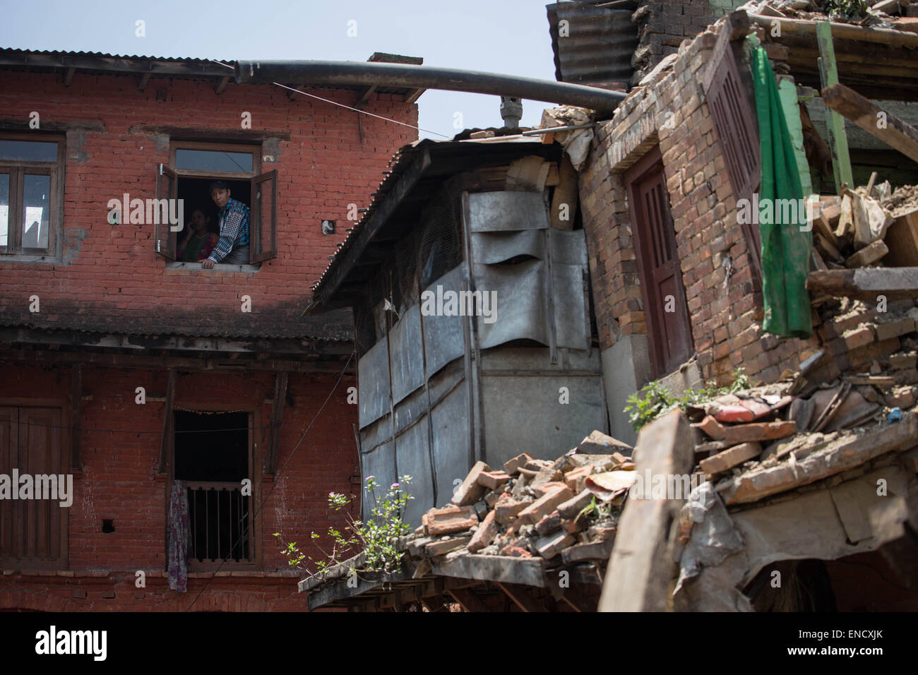 Kathmandu, Nepal. 2nd May, 2015. Local couple watch the disaster caused by the earthquake from their window. Credit:  Guillaume Payen/ZUMA Wire/ZUMAPRESS.com/Alamy Live News Stock Photo