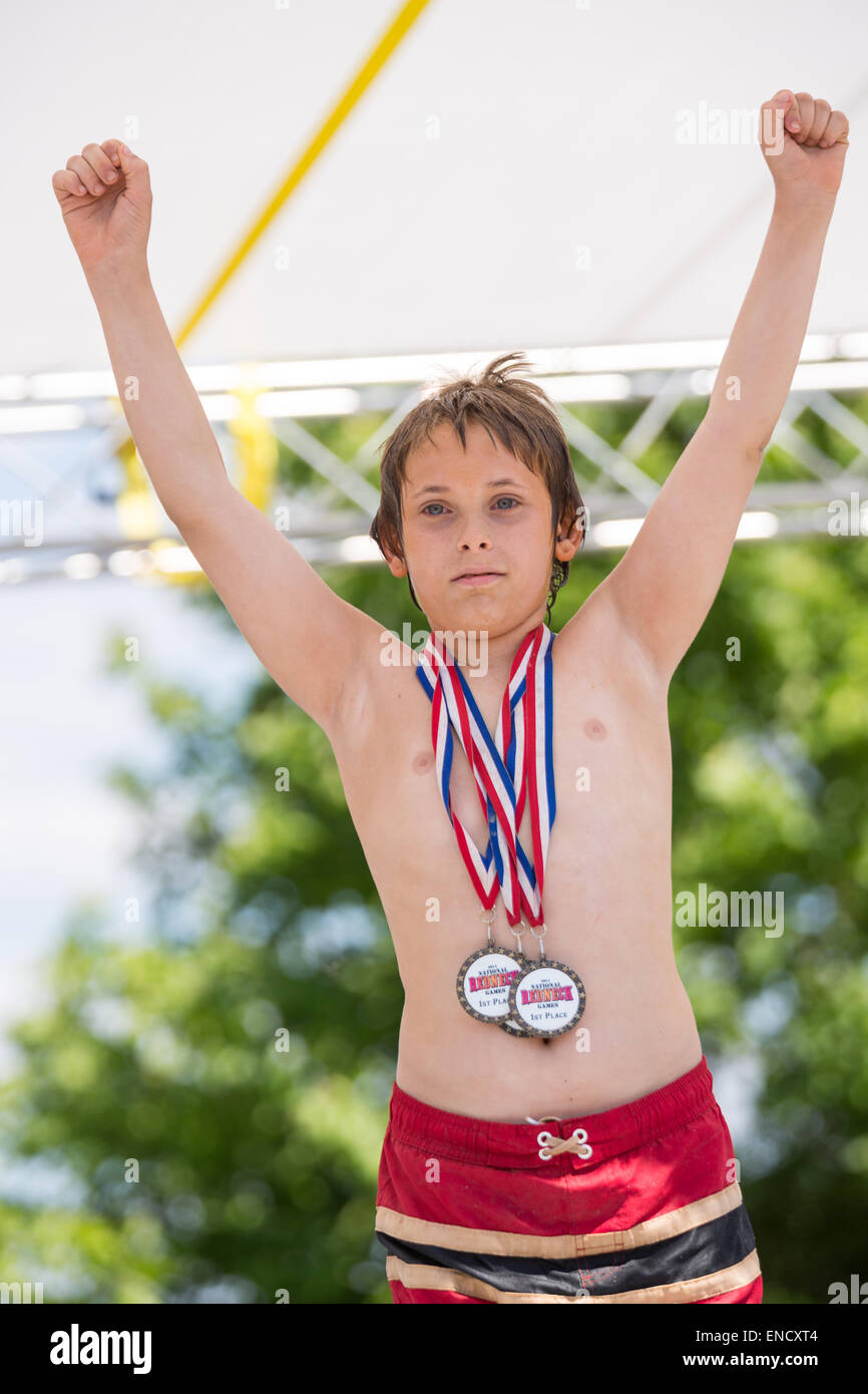 Augusta, Georgia, USA. 2nd May, 2015. A young boy raises his hands in victory after winning the overall champion Red Neck during the 2015 National Red Neck Championships May 2, 2015 in Augusta, Georgia. Hundreds of people joined in a day of country sport and activities. Stock Photo