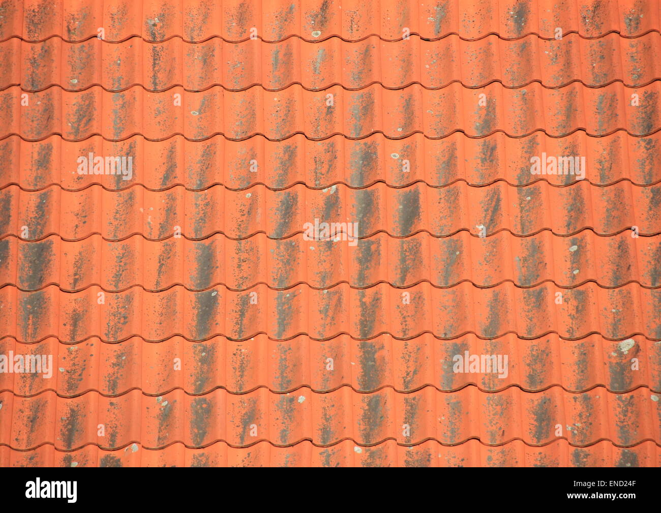 Old red roof tiles with black patina Stock Photo
