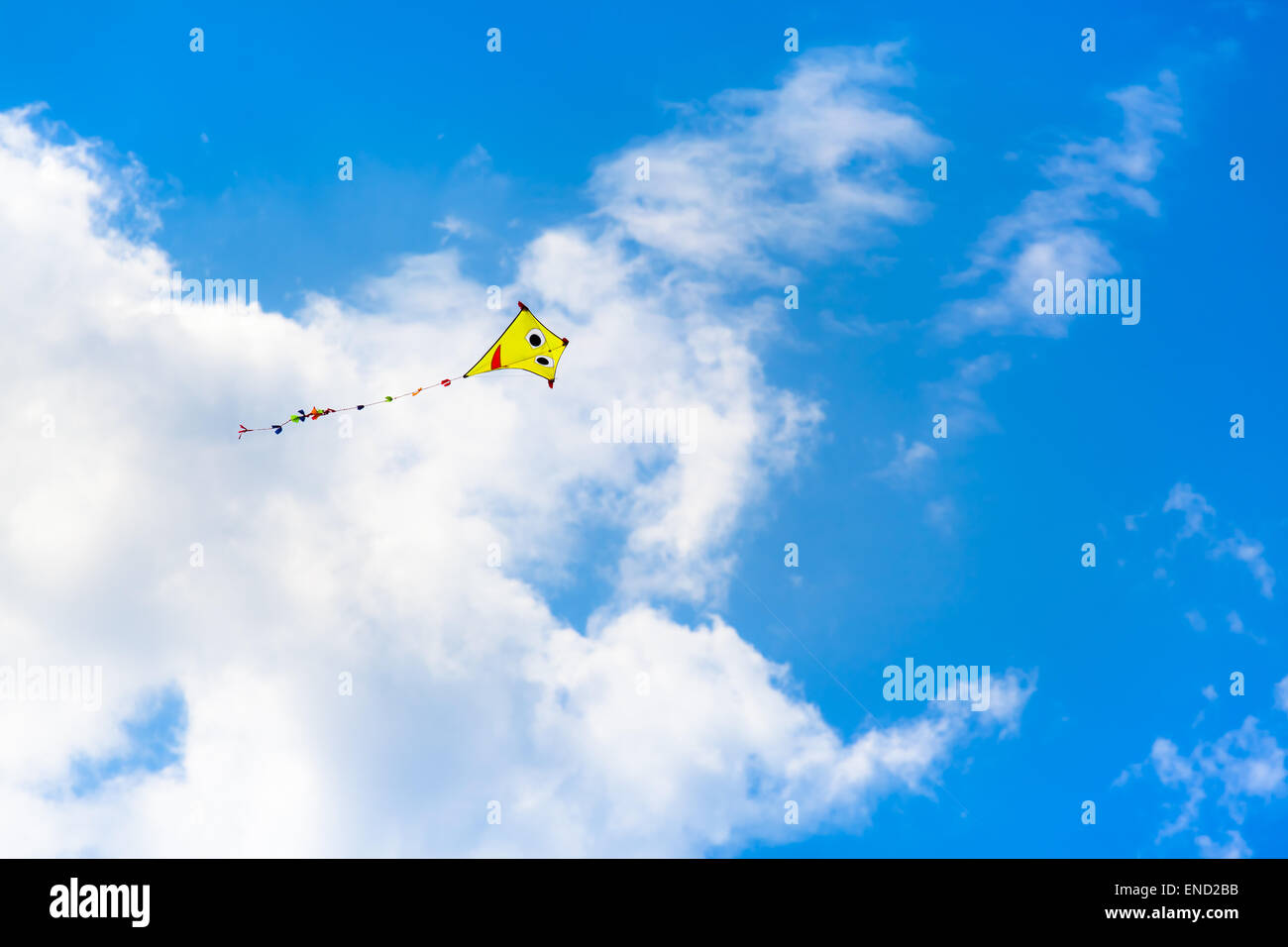 The Kite at the Sky - Colorful kite is flying at the summery sky Stock Photo