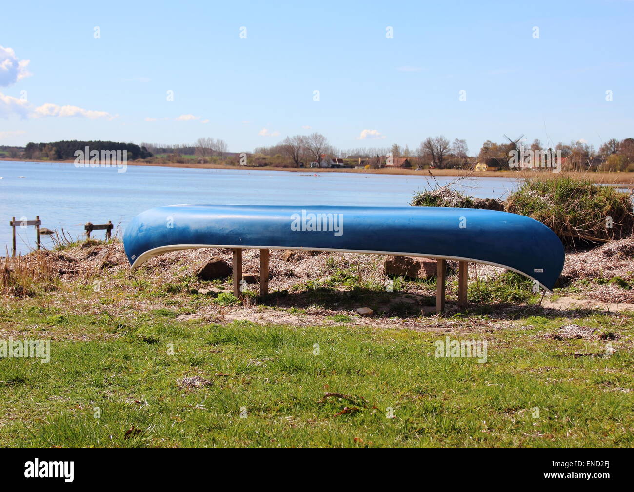 Canoe placed at beach with blue sky and water front Stock Photo