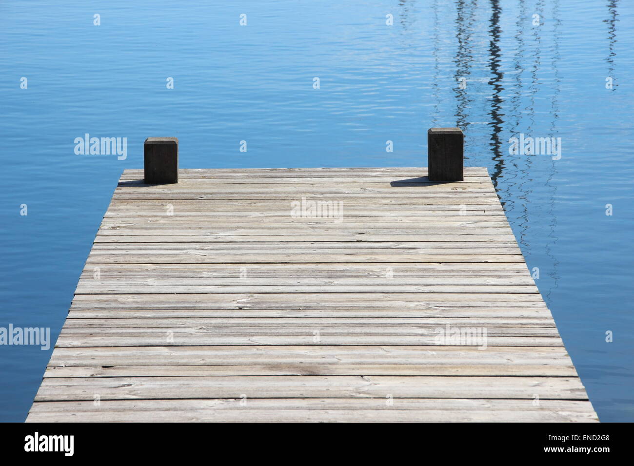 Bathing jetty and landing stage for boats with blue water Stock Photo