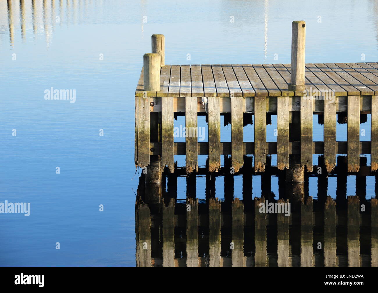 Bathing jetty and landing stage for boats with water reflection Stock Photo