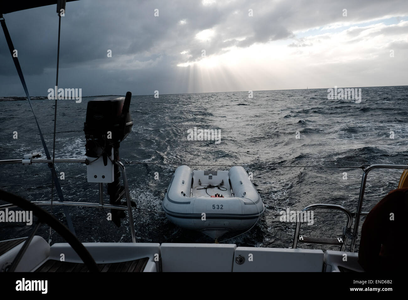 Yacht towing a dinghy in the carribean Stock Photo Alamy