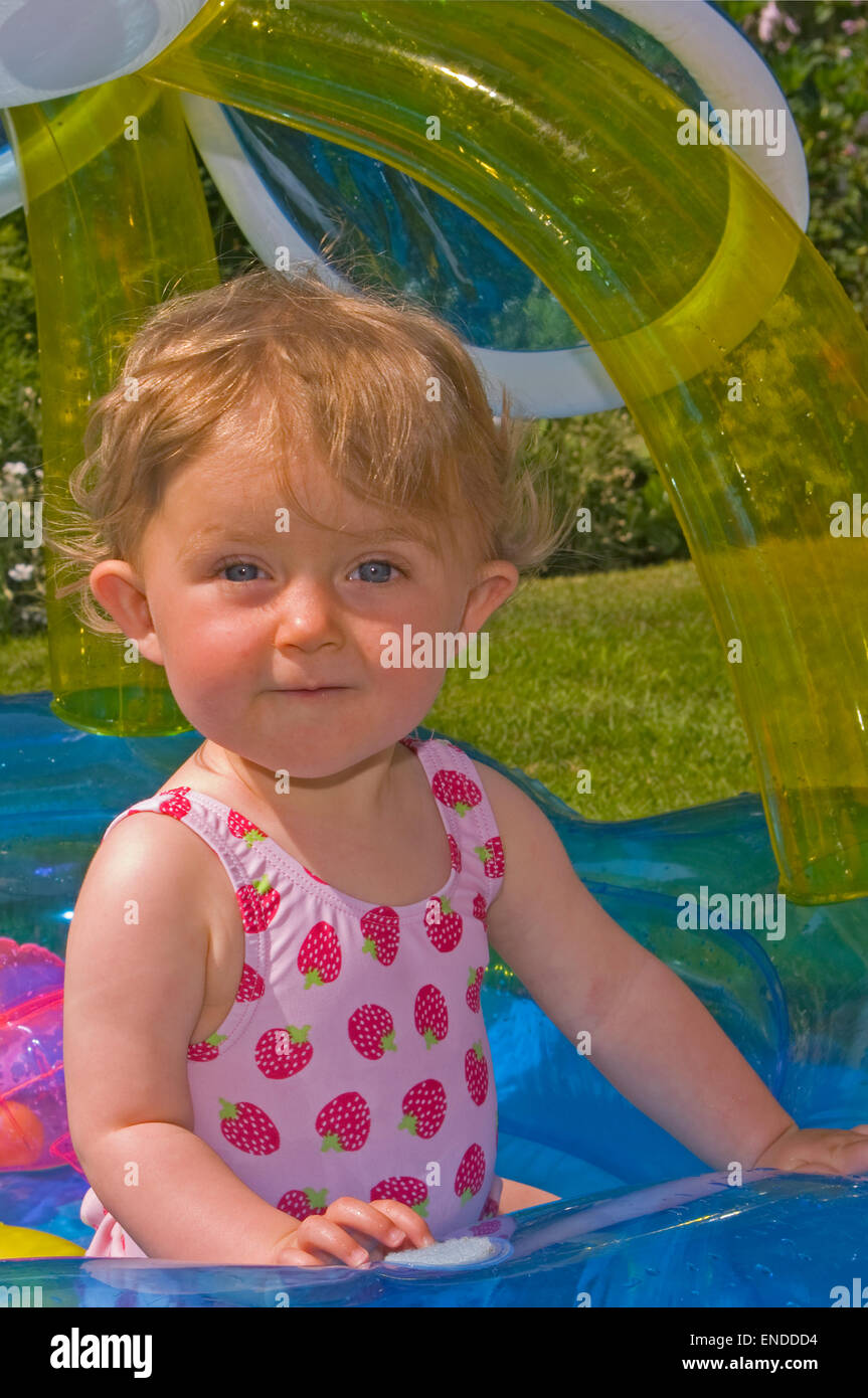 Baby Girl Playing In a Paddling Pool Stock Photo Alamy