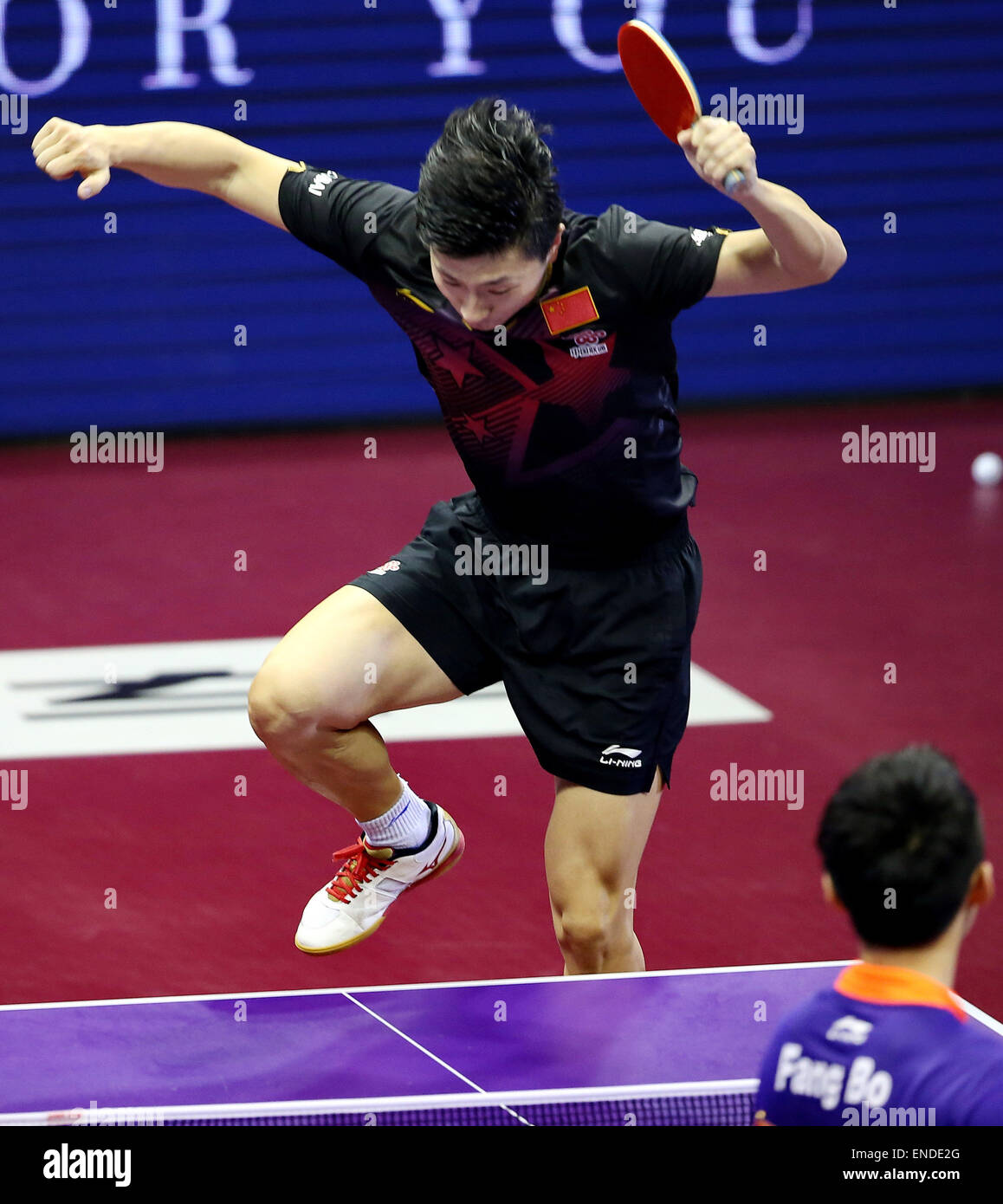 Suzhou, China's Jiangsu Province. 3rd May, 2015. China's Ma Long jump onto the table to celebrate the victory after Men's Singles Final against his compatriot Fang Bo at the 53rd Table Tennis World Championships in Suzhou, city of east China's Jiangsu Province, on May 3, 2015. Ma Long won 4-2 and claimed the title. Credit:  Yang Shiyao/Xinhua/Alamy Live News Stock Photo