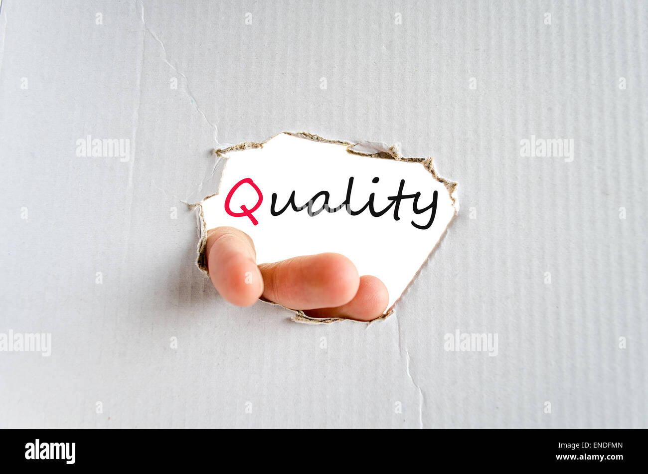 Hand on the cardboard background quality concept Stock Photo