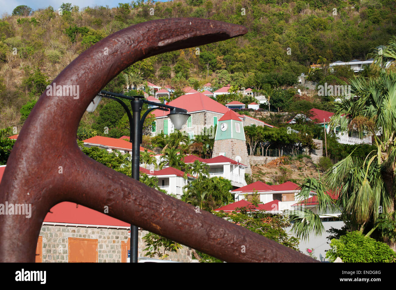 St. Barths, Saint-Barthélemy, French West Indies, Caribbean: an anchor in the center of Gustavia and the Swedish Clock Tower and Belfry Stock Photo