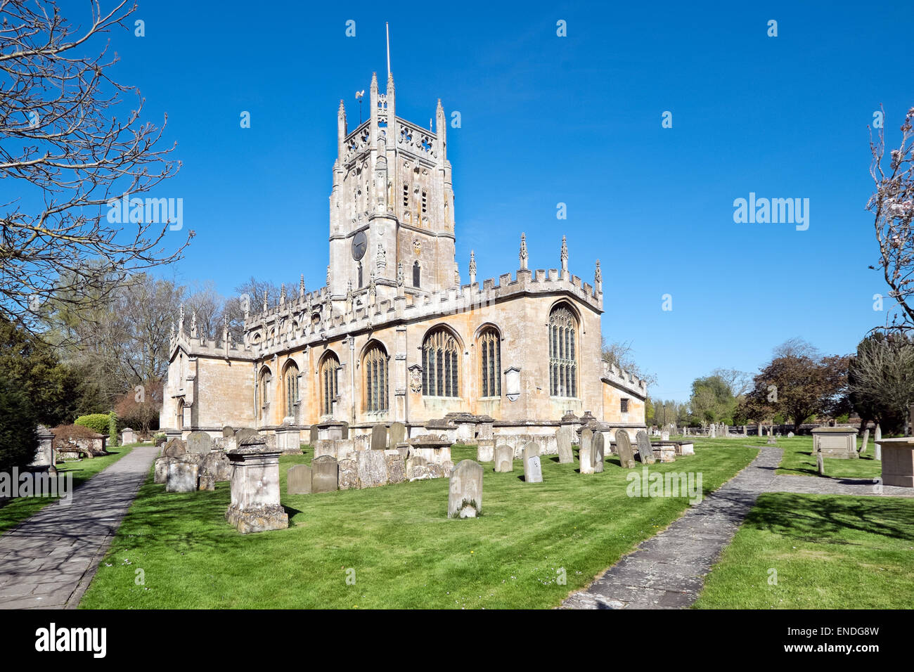 St Mary's Church & graveyard in the village of Fairford, Gloucestershire on a sunny day Stock Photo