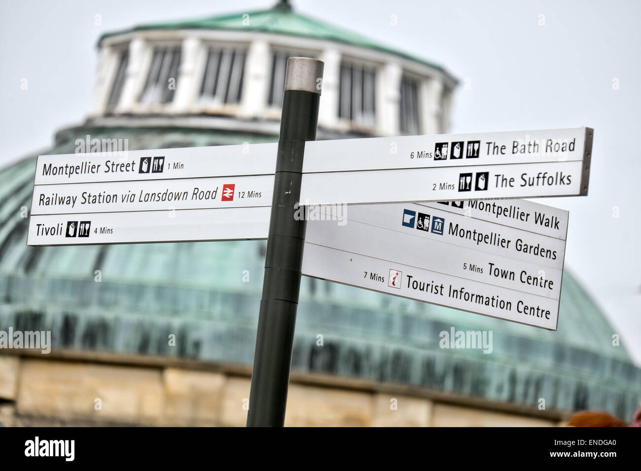 The defocused roof of the Rotunda in Cheltenham's Montpellier district behind a sign showing directions to the areas key places Stock Photo